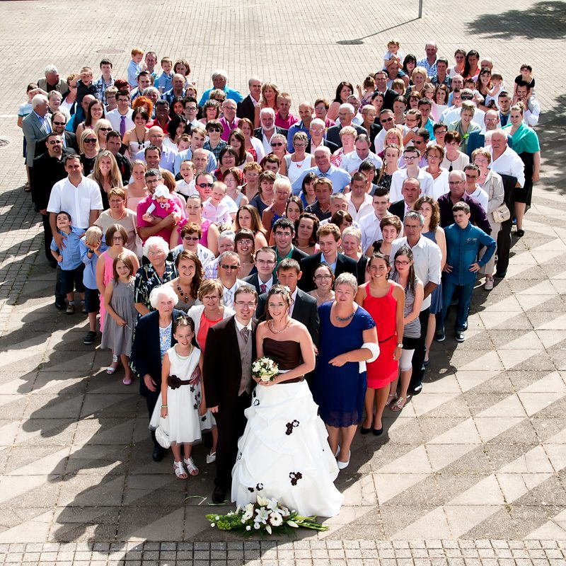 Le point de vue en photographie-plongée-mariés et leurs invités formant un cœur